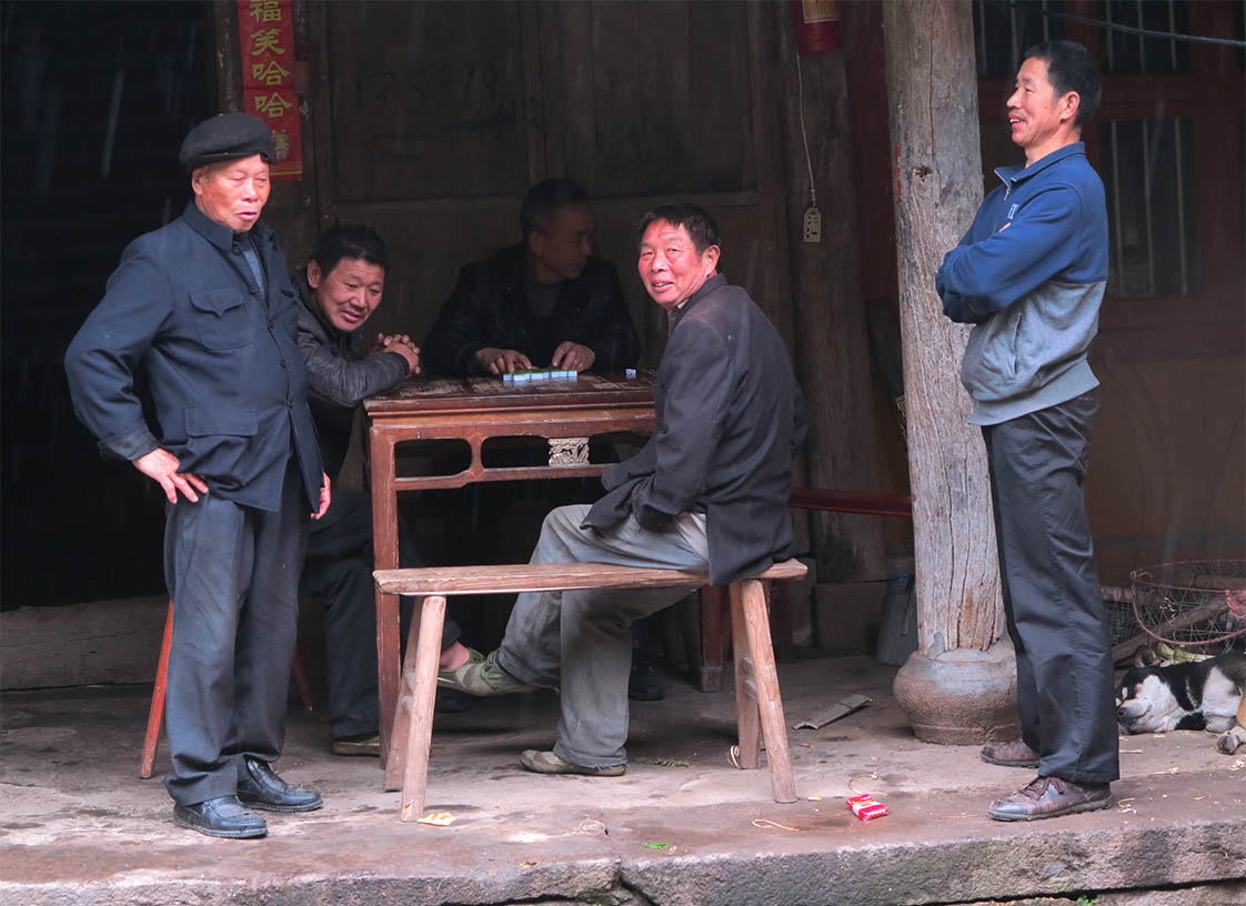 Village men enjoy a local version of Mah-jong. (Jock Lauterer photo)