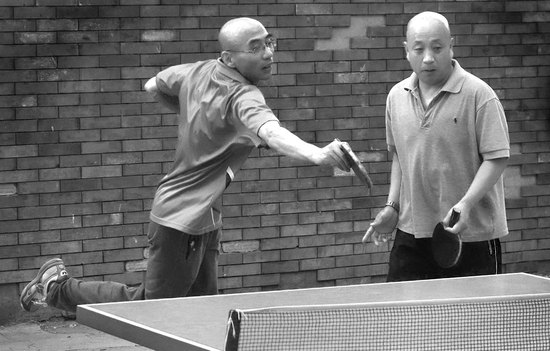 Ping pong is huge in China. At a Beijing park, a doubles match rages.