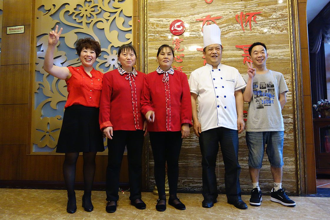 The irrepressible Mrs. Qin and the staff of the "Don't Worry Be Happy Hotel" in Chongqing give me a merry send-off.