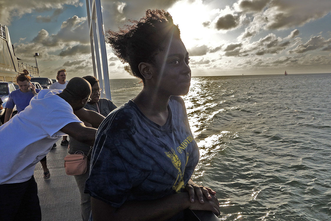 With the wind in her hair, Natasha Graham savors her first boat ride as the ferry crosses the sound from Swan Quarter to Ocracoke. (Jock Lauterer photo)