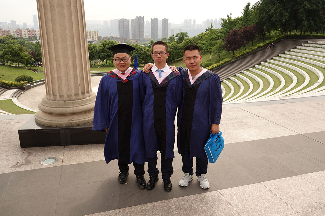 With their burgeoning city of 7 million rising in the background, three friends pose before their June graduation from Southwest University of Political Science and Law in Chongqing. (Jock Lauterer photos)