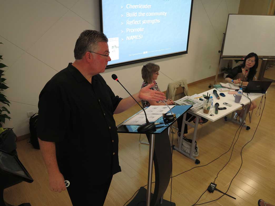 Bill Horner lectures in Shanghai as wife Lee Ann, center, listens while Prof Chen Kai translates. Jock Lauterer photo