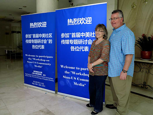 The Horners pose in front of the workshop banner in Shanghai. (Jock Lauterer photo)