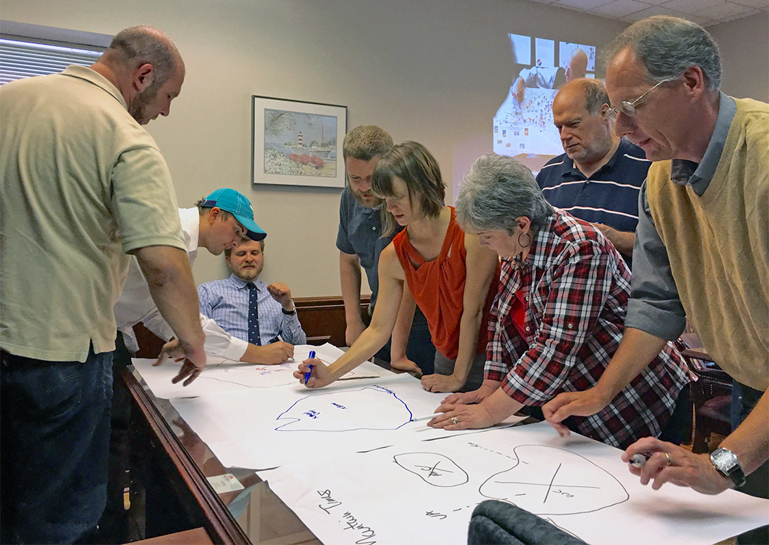 Journalists from five newspapers assemble in Boone, Friday, June 3, to participate in an interactive workshop to better their skills as community journalists. (Jock Lauterer photo)