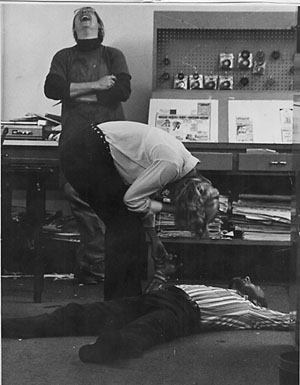 High quality community journalism was typically accompanied by gonzo behavior at THIS WEEK in Forest City. Co-editor Jock Lauterer and typesetting Billie Faulkner crack up after Ron Paris has unsuccessfully attempted a cartwheel. (Photo by Joy Franklin)