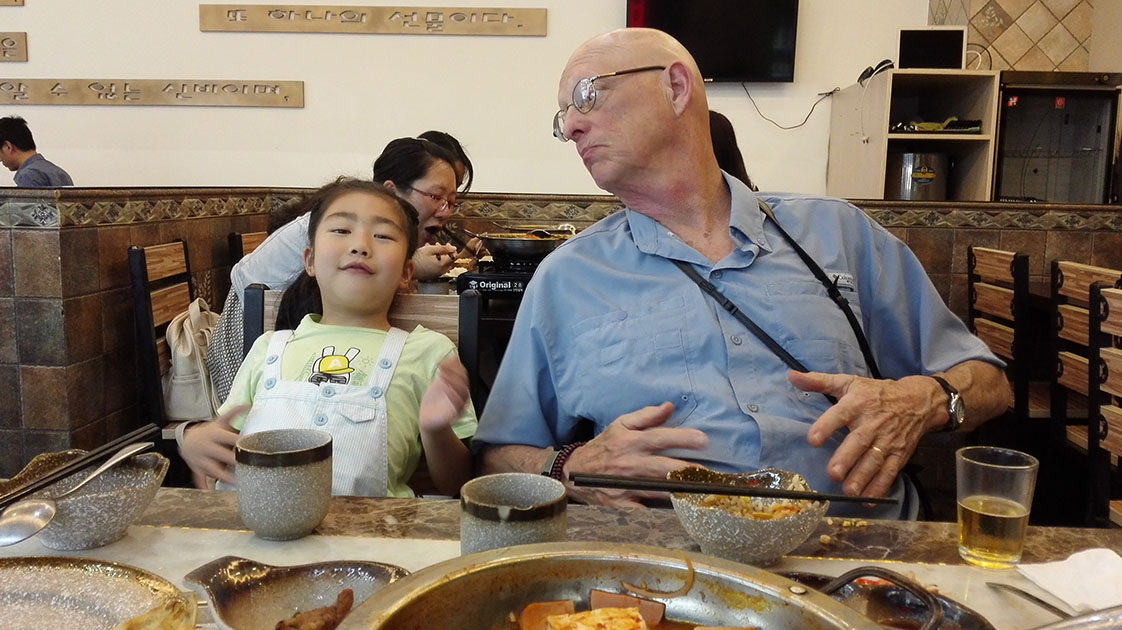 Mr. Joke and "Alice," my host's 7-year-old daughter, signal the end of another successful meal. (Ren Li photo)